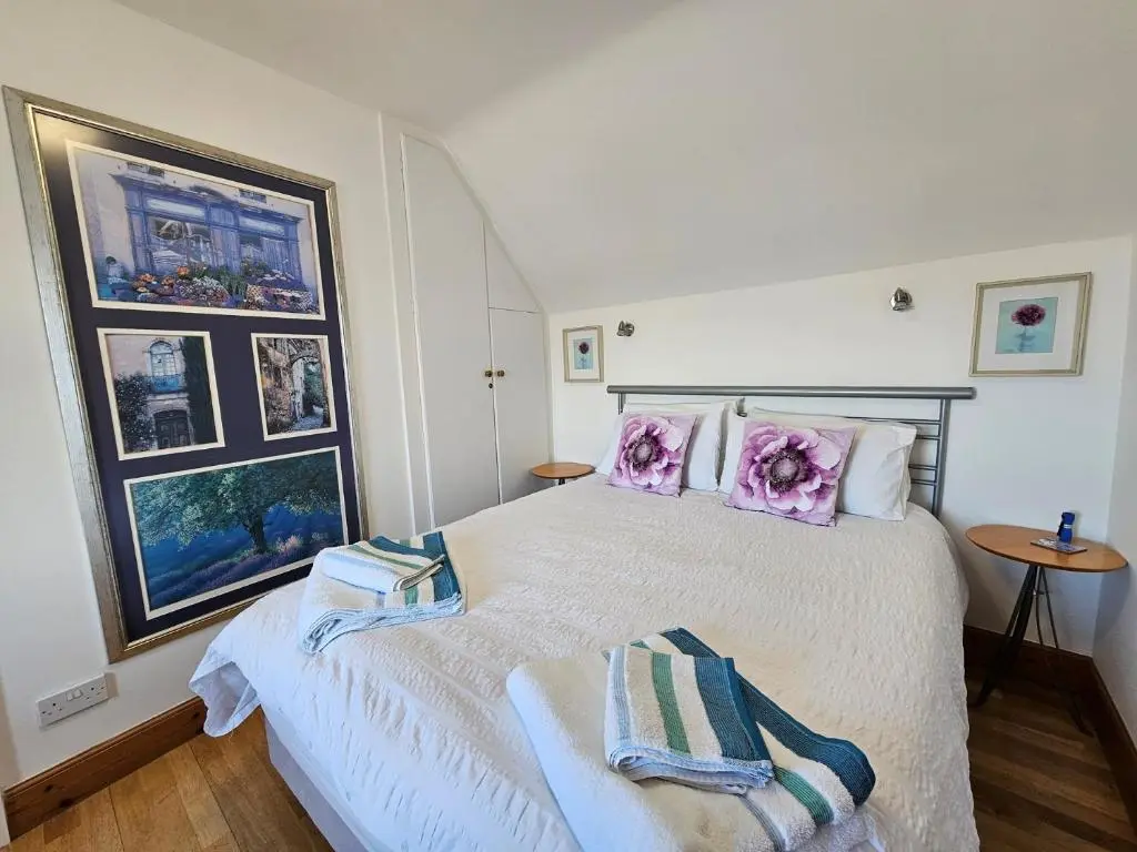 a bedroom with a bed with two towels on it at 2 Bed in Findochty 76557 in Findochty