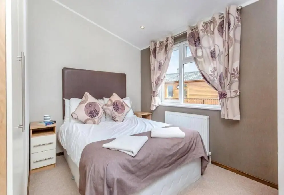 a bedroom with a bed and a window at Scottish retreat in Banchory