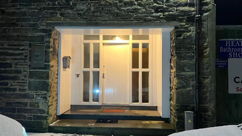 a white door in a brick building at The Old Salt House, Flat 2 in Wick