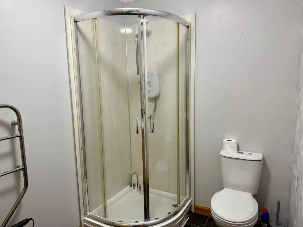 a shower stall with a toilet in a bathroom at The Old Salt House, Flat 2 in Wick