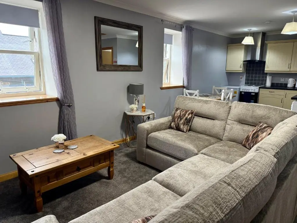 a living room with a couch and a table at The Old Salt House, Flat 2 in Wick