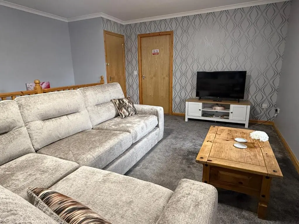 a living room with a couch and a coffee table at The Old Salt House, Flat 2 in Wick