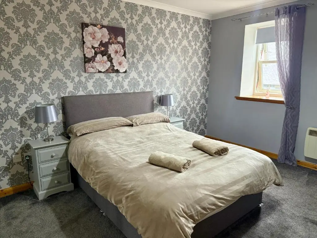 a bedroom with a bed with two pillows on it at The Old Salt House, Flat 2 in Wick