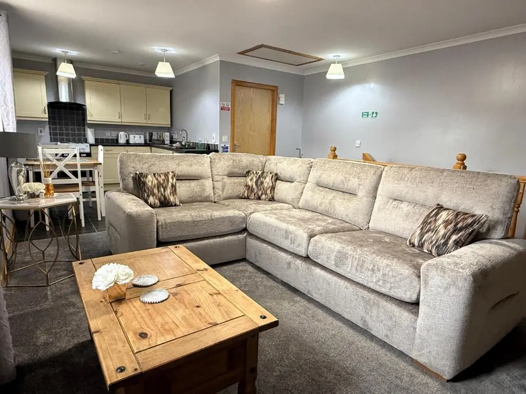 a living room with a couch and a coffee table at The Old Salt House, Flat 2 in Wick
