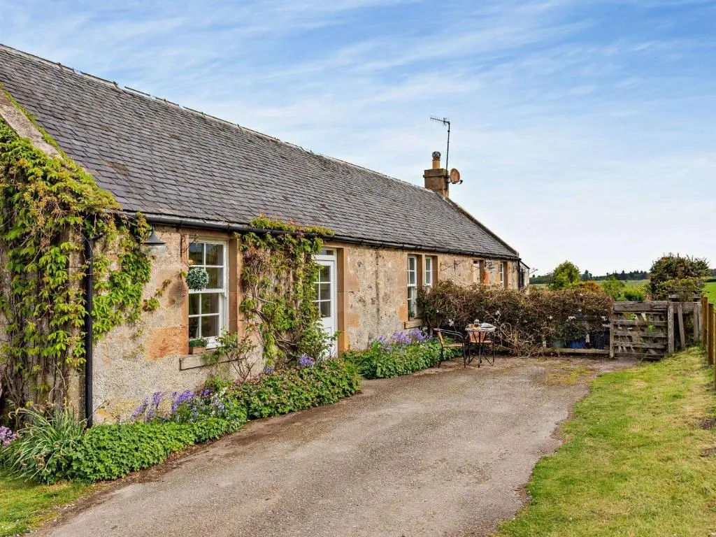 an old stone house with ivy growing on it at 2 Bed in Conon Bridge CA387 in Cononbridge