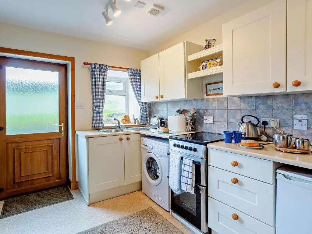 a kitchen with a stove and a dishwasher at 1 Bed in Beauly 82778 in Beauly
