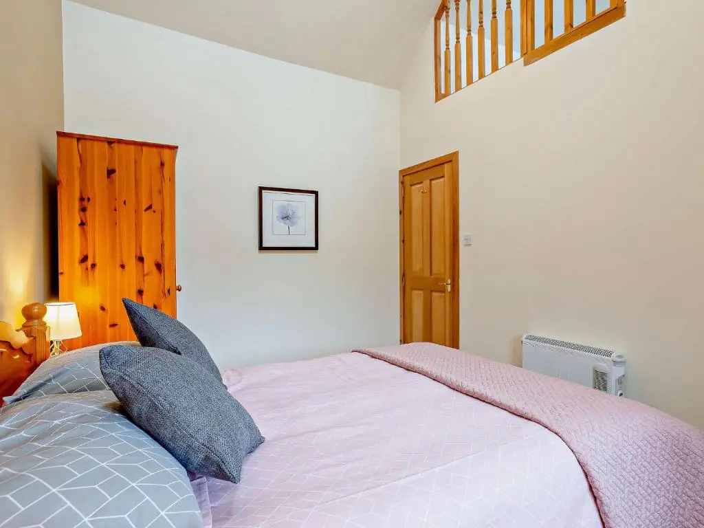 a bedroom with a large bed with pillows at 1 Bed in Beauly 82778 in Beauly