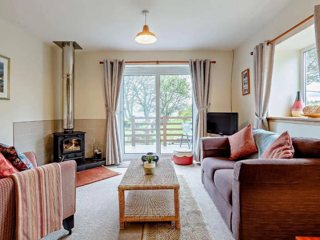 a living room with two couches and a fireplace at 1 Bed in Beauly 82778 in Beauly