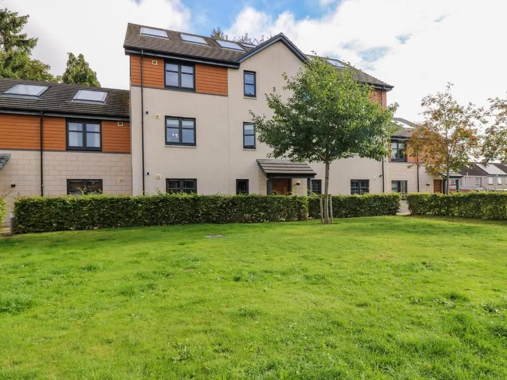 a large house with a green yard in front of it at 11 Ambleside Court in Banchory