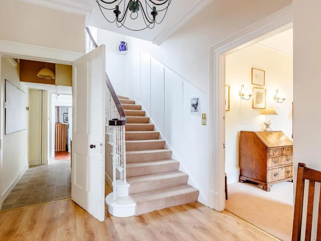 a staircase in a home with white walls and wood floors at 5 Bed in Blacklunans CA409 in Cray