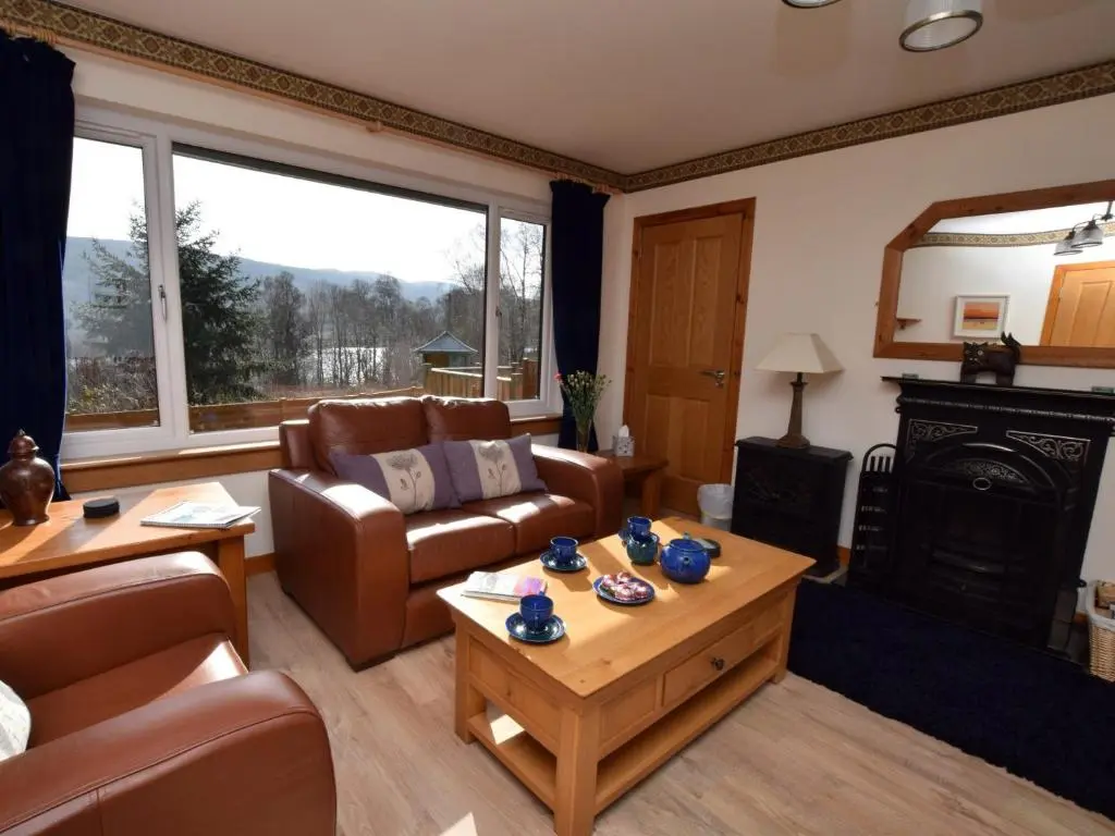 a living room with a couch and a fireplace at 3 Bed in Drumnadrochit IN633 in Balnain