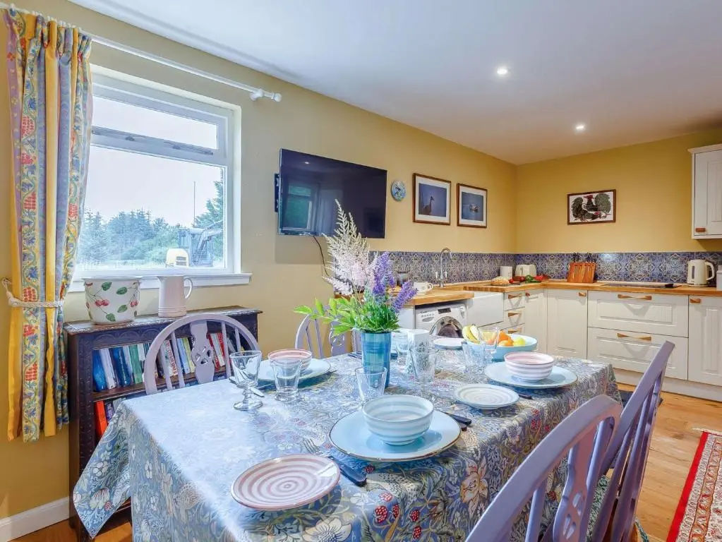 a kitchen with a table with plates on it at 1 Bed in Balblair 89058 in Culrain