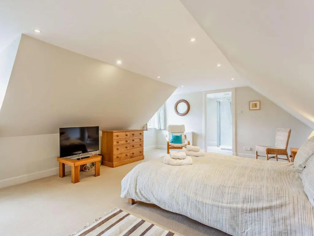 a bedroom with a large bed and a television at 3 Bed in Conon Bridge CA388 in Cononbridge