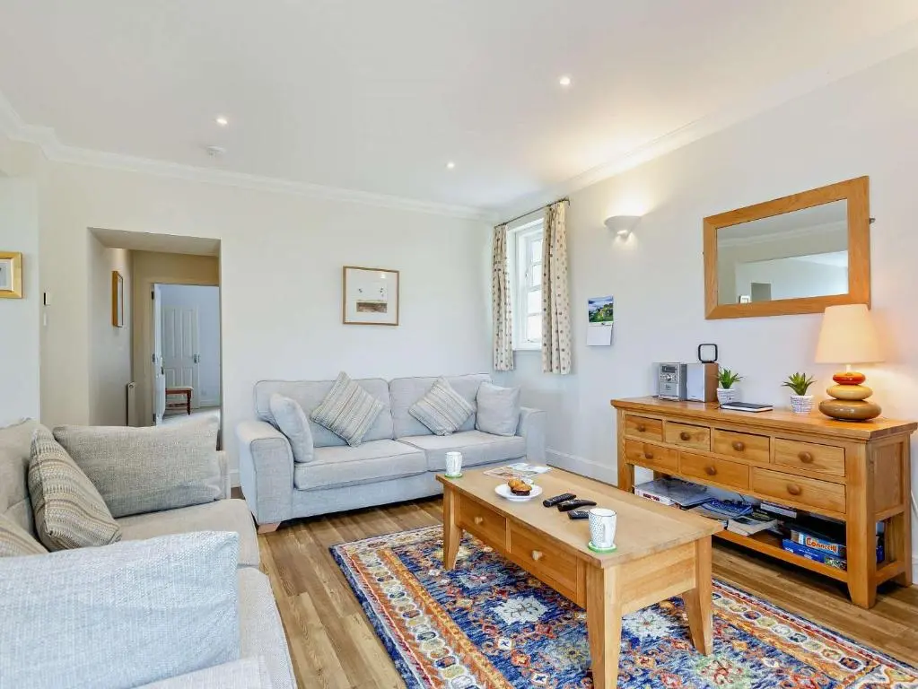a living room with a couch and a table at 3 Bed in Conon Bridge CA388 in Cononbridge