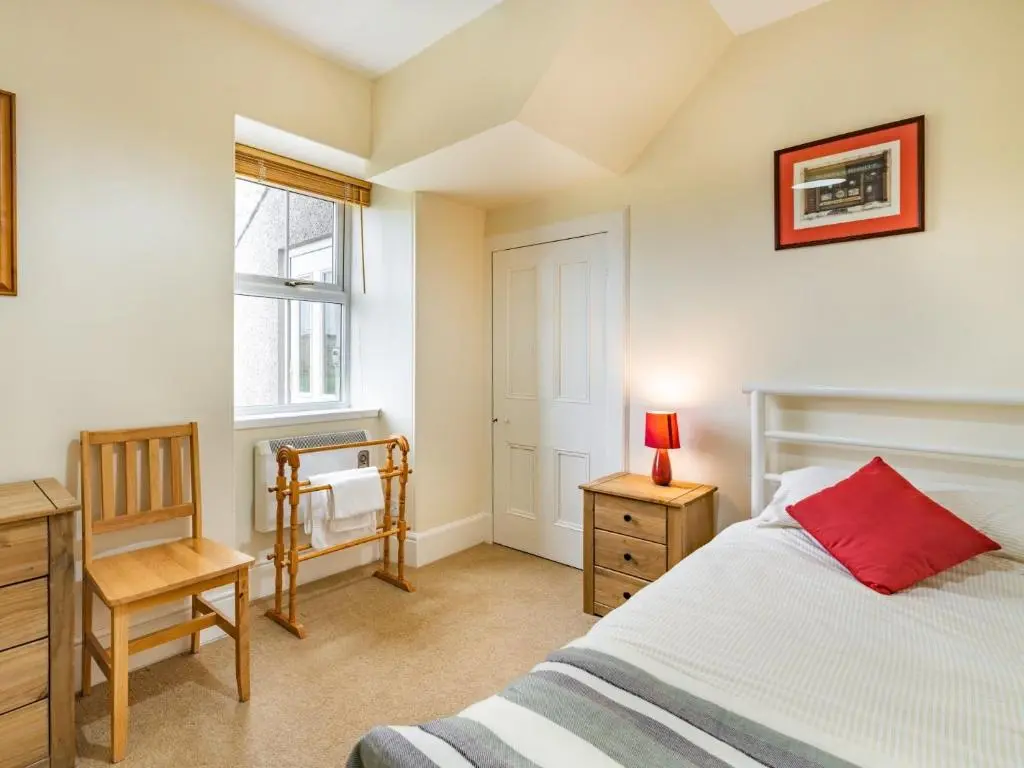 a bedroom with a bed and a desk and a window at 3 Bed in Carron CA227 in Carron