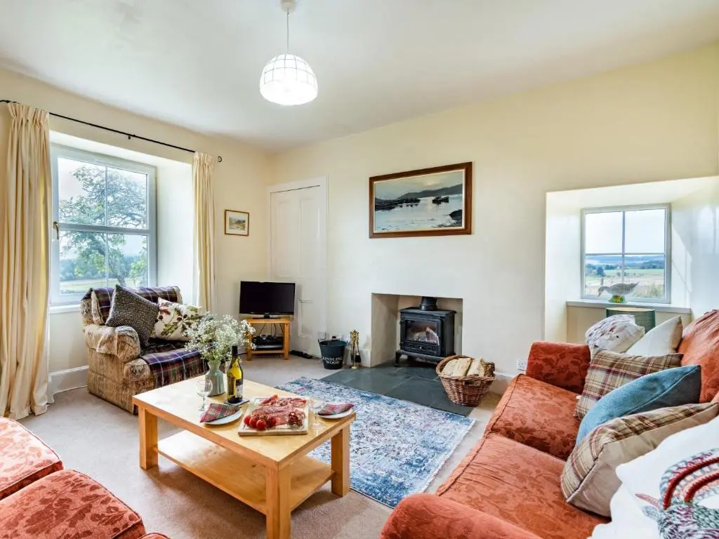 a living room with a couch and a table at 3 Bed in Carron CA227 in Carron