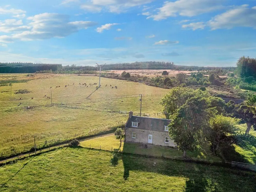 an old house in the middle of a field with animals at 3 Bed in Carron CA227 in Carron