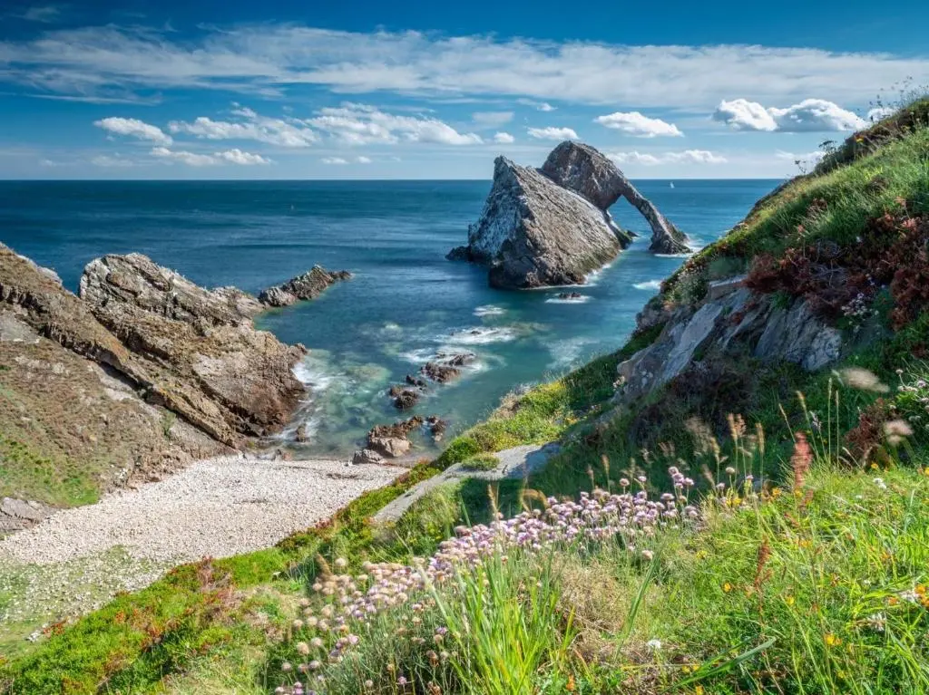 a view of the ocean from a cliff with flowers at 3 Bed in Carron CA227 in Carron