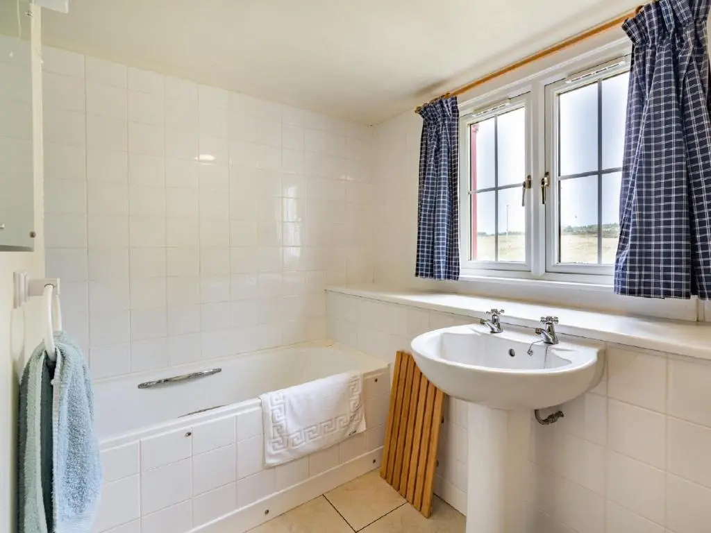 a bathroom with a sink and a bath tub and a sink at 3 Bed in Carron CA227 in Carron