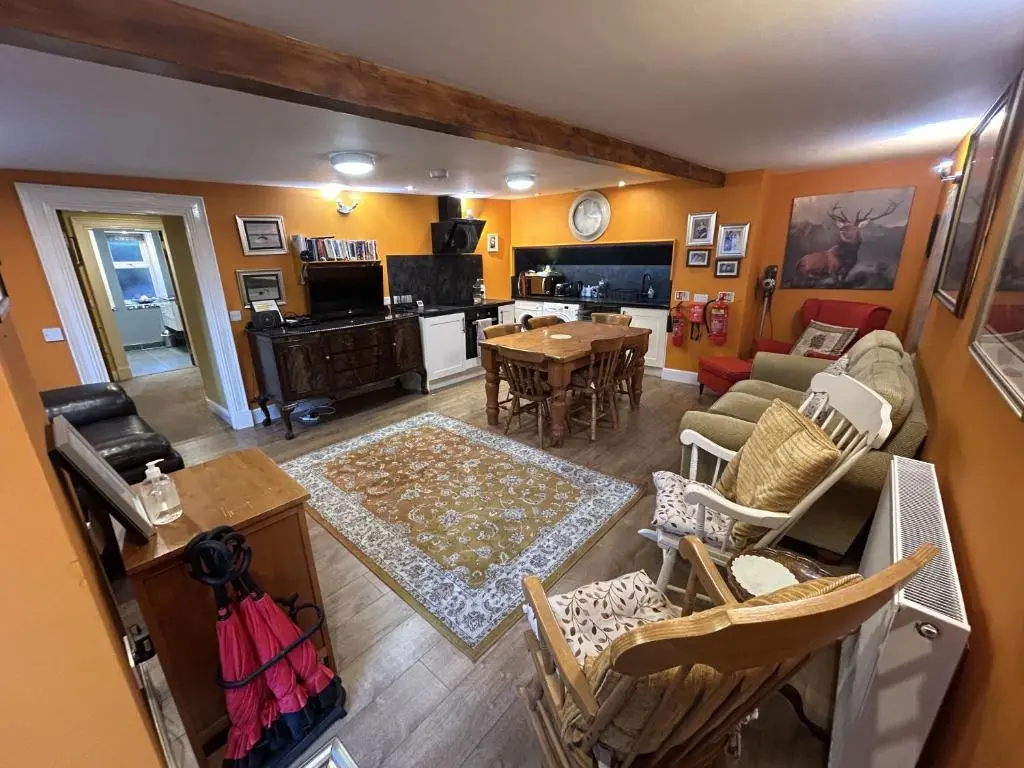 an aerial view of a living room and dining room at The Secret Garden at Old Drynie House - Self Catering in Inverness