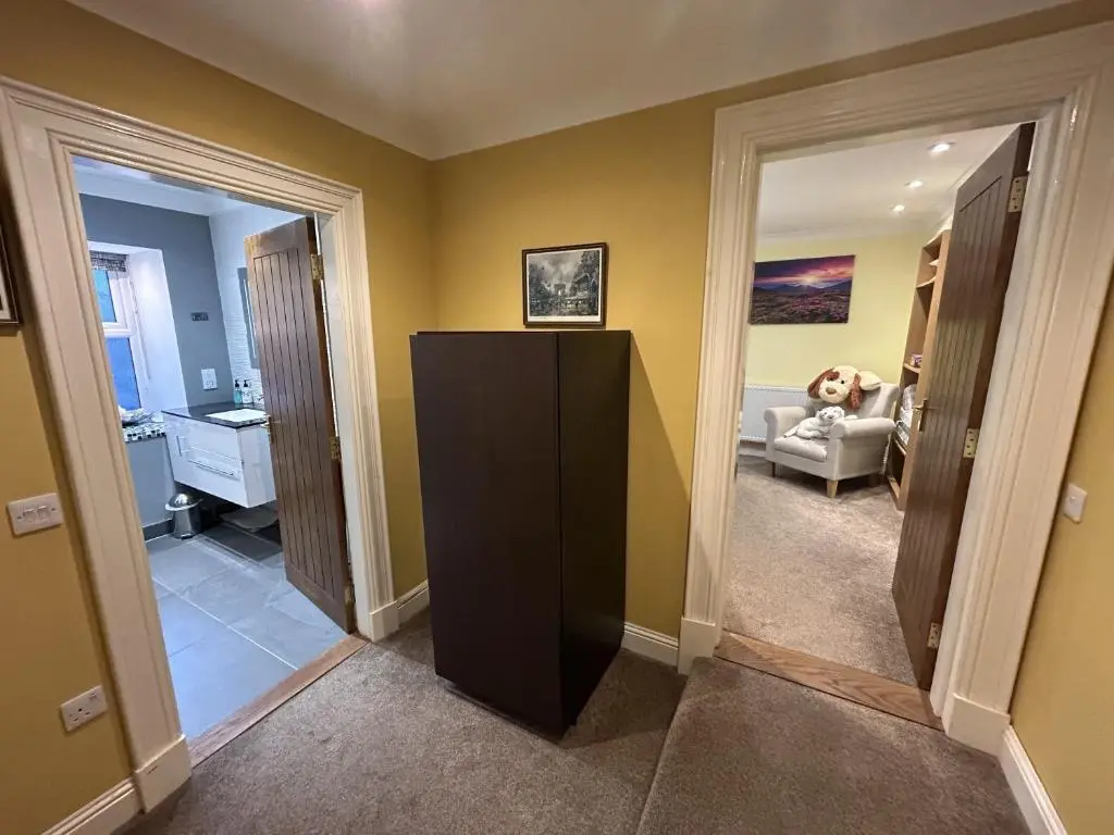a living room with a black cabinet in a room at The Secret Garden at Old Drynie House - Self Catering in Inverness