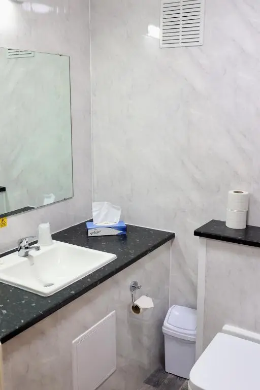 a bathroom with a sink and a toilet and a mirror at Britannia Hotel Aberdeen in Aberdeen