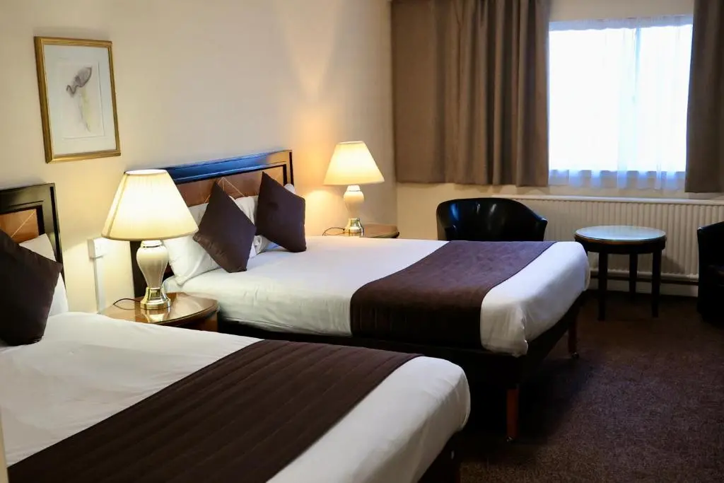a hotel room with two beds and a window at Britannia Hotel Aberdeen in Aberdeen