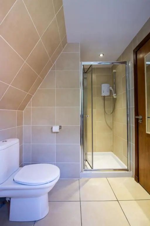 a bathroom with a toilet and a shower at Chalet Caledonia Lodge by Interhome in Spean Bridge