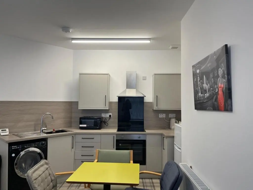 a kitchen with a table and a yellow table at Buckie Haven 3 Bed Contractors Business Travellers in Buckie