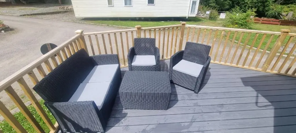 a group of benches sitting on a wooden deck at Lynton lodges ATLAS in Evanton