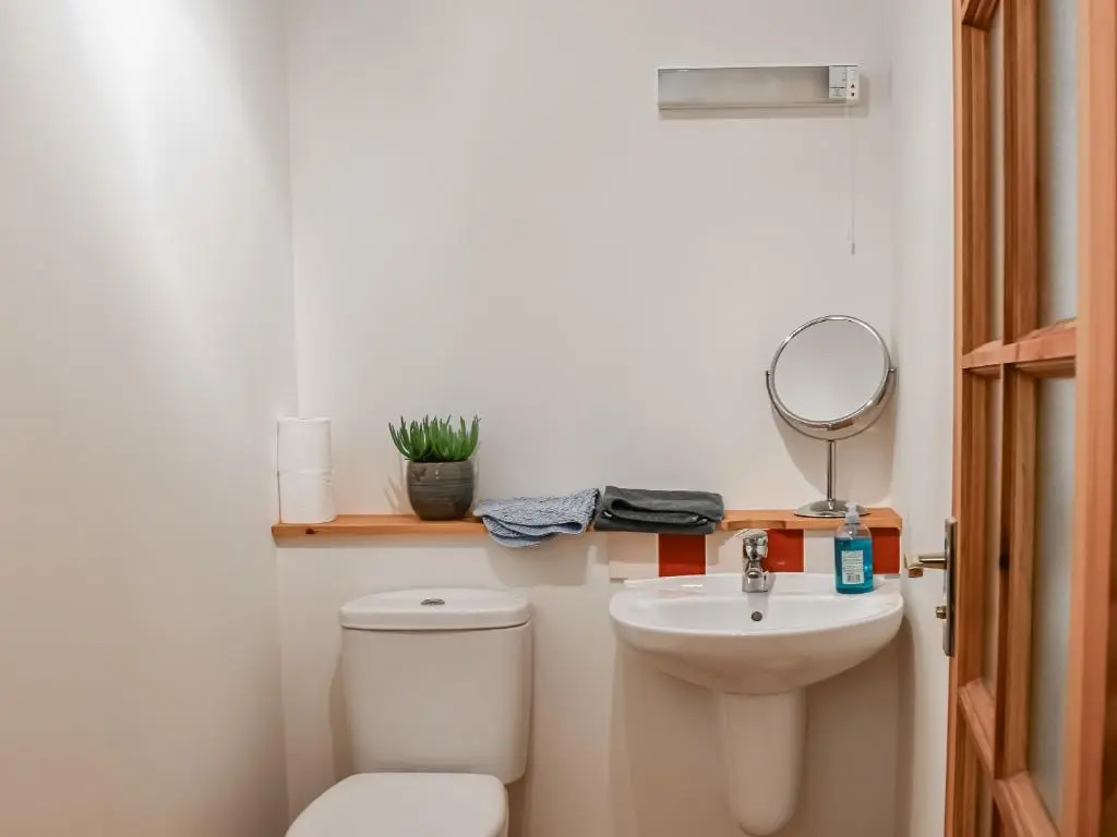 a small bathroom with a toilet and a sink at Sycamore Cottage - Uk45923 in Ballater