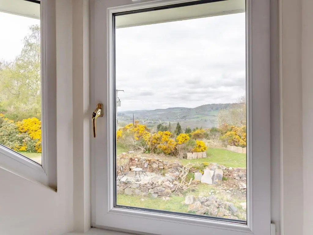 an open window with a view of a yard at 2 bed in Loch Ness CA315 in Drumnadrochit
