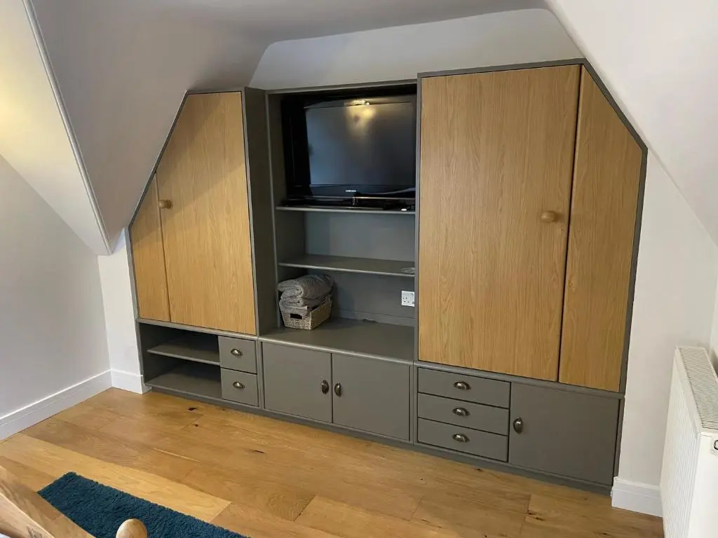 a large entertainment center with a television in it at Braemorriston Lodge in Elgin