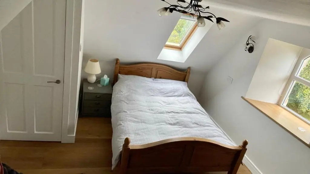 a bedroom with a bed in a room with a window at Braemorriston Lodge in Elgin