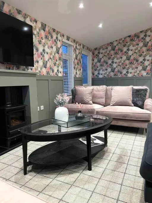 a living room with a couch and a coffee table at Luxury Lodge With Hot Tub In Royal Deeside in Strachan