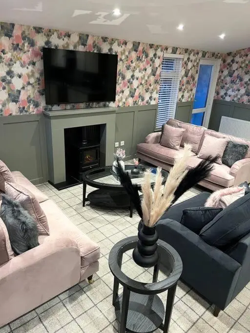 a living room with two couches and a fireplace at Luxury Lodge With Hot Tub In Royal Deeside in Strachan