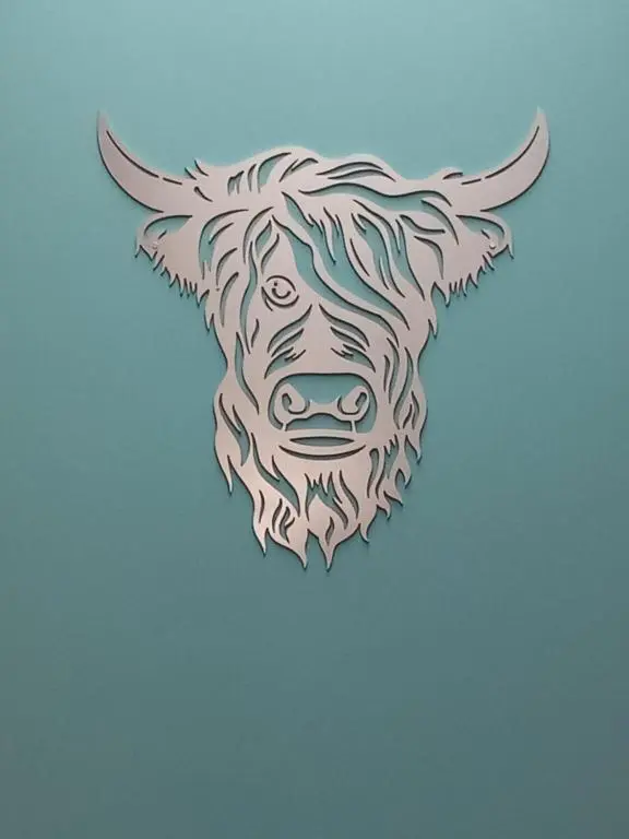 a head of a cow on a blue background at The Coo Shed in Inverness