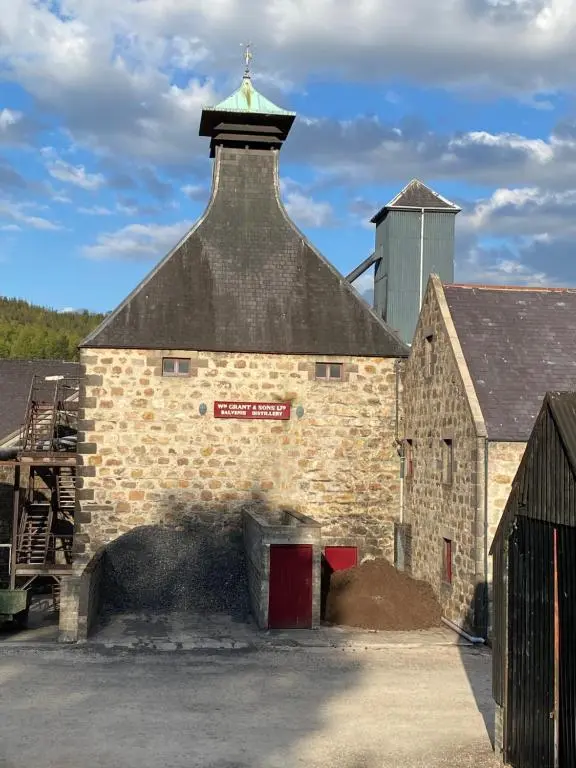 a large brick building with a tower on top of it at Lyngarrie in Dufftown