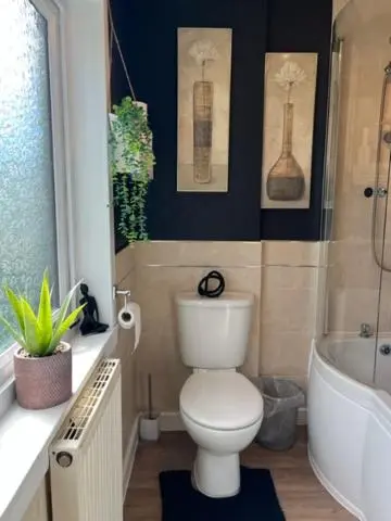 a bathroom with a toilet and a tub and a sink at Above the harbour wick in Wick