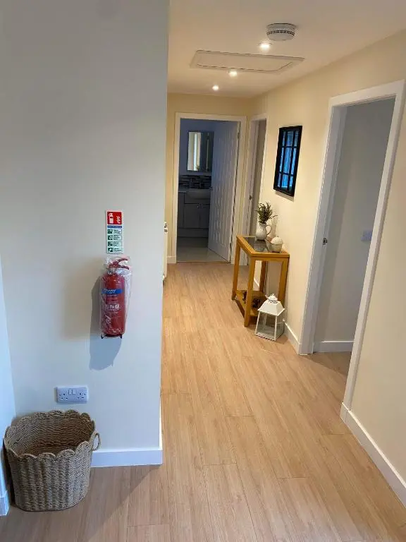 a living room with a hallway with a fire hydrant on the wall at Beldorny in Kingston