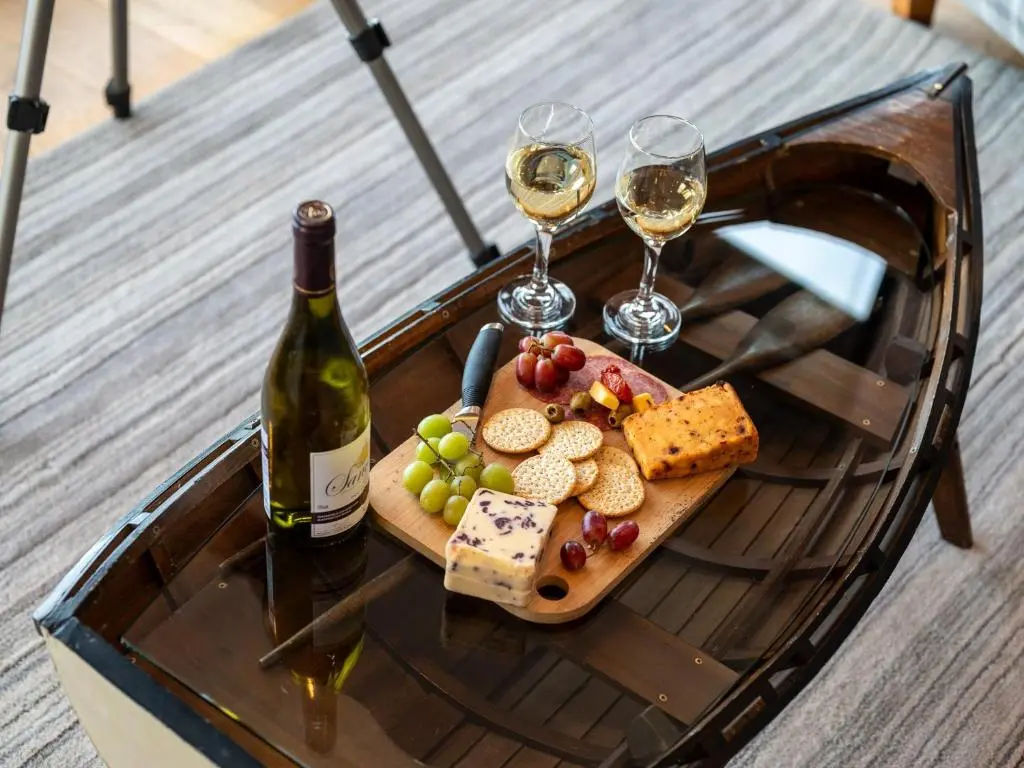 a table with two glasses of wine and a plate of food at 2 Bed in South Kessock CA324 in Inverness
