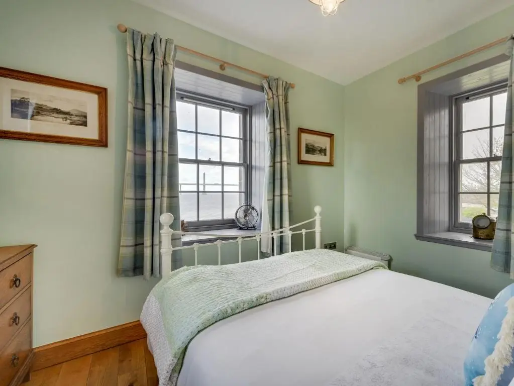 a bedroom with a bed and two windows at 2 Bed in South Kessock CA324 in Inverness