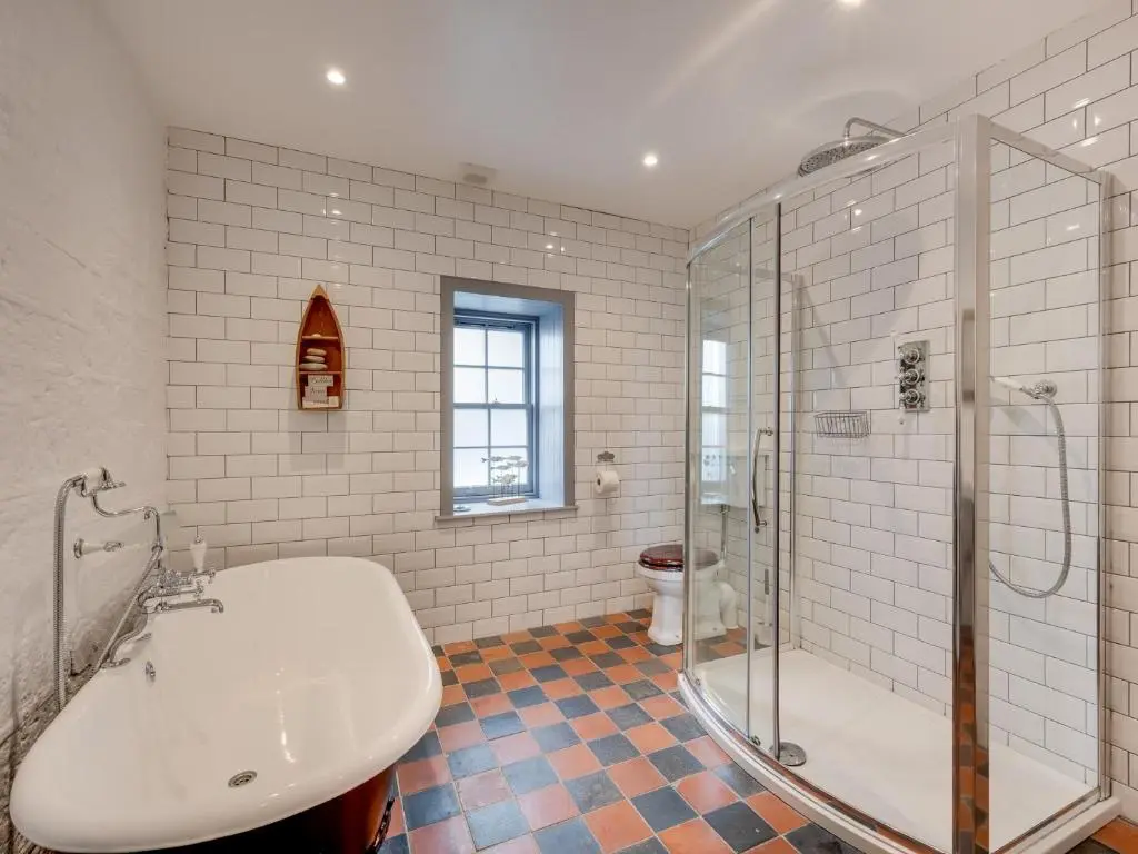 a bathroom with a shower and a tub and a toilet at 2 Bed in South Kessock CA324 in Inverness
