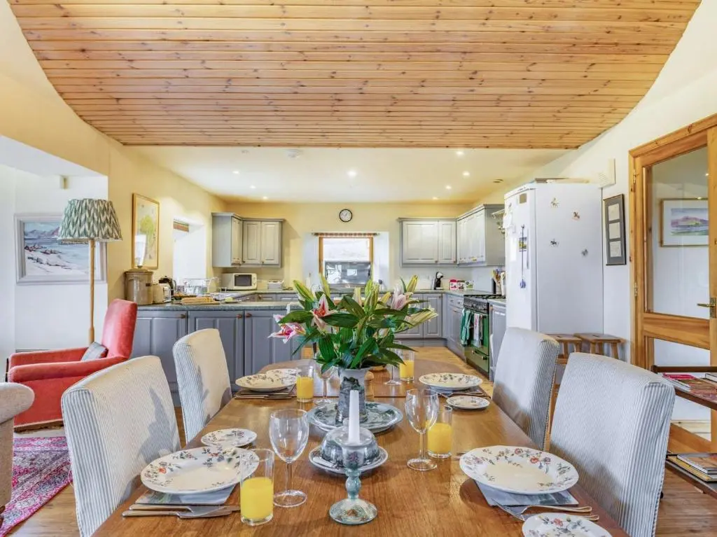 a kitchen and dining room with a table and chairs at 4 Bed in Grantown-on-Spey CA383 in Aitnoch
