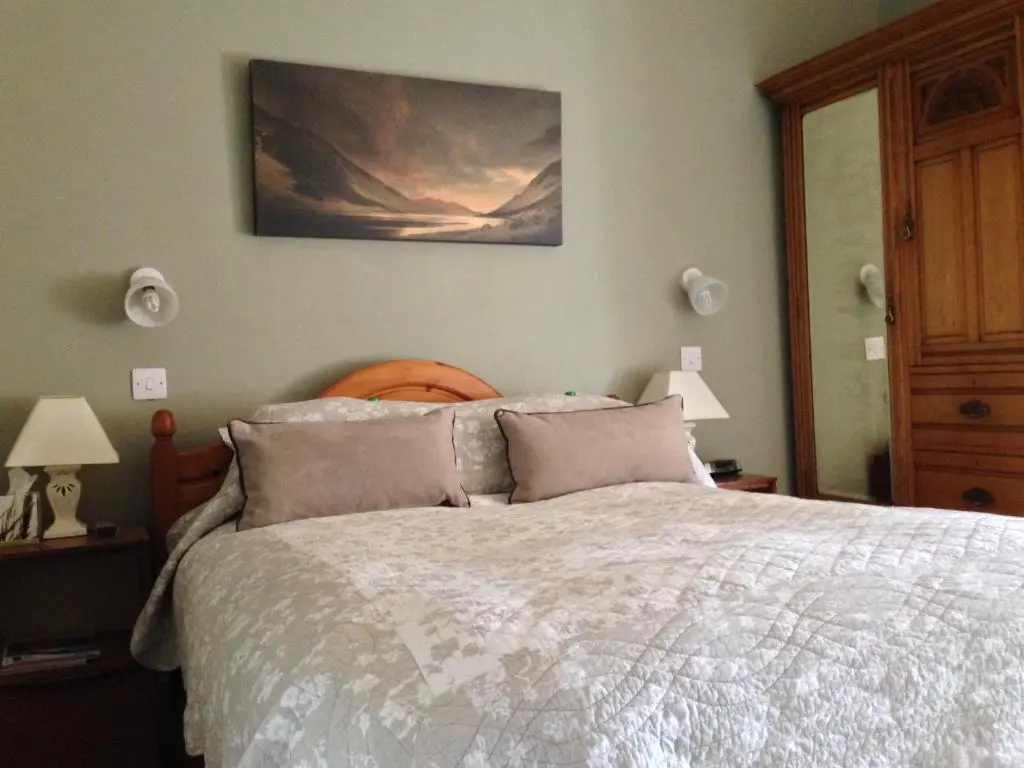 a bedroom with a bed and a painting on the wall at The Anderson in Fortrose