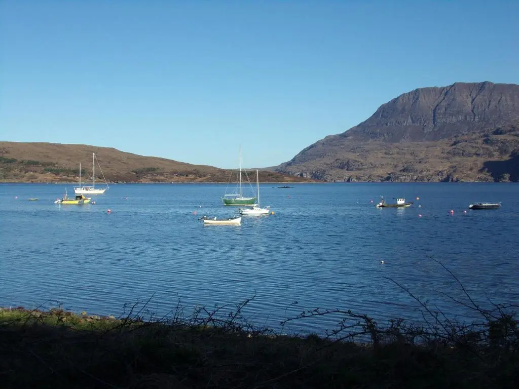 a group of boats floating on a large body of water at Caledonian Hotel 'A Bespoke Hotel\u2019 in Ullapool