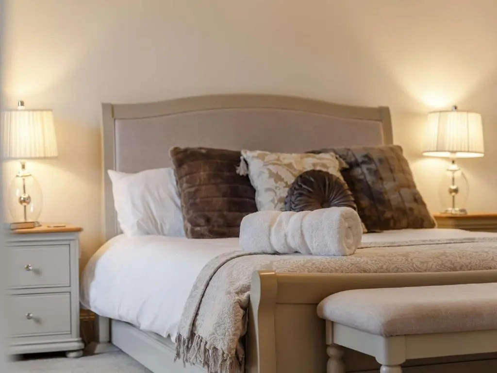 a bedroom with a large bed with pillows and two lamps at 4 Bed in Wick 91390 in Wick