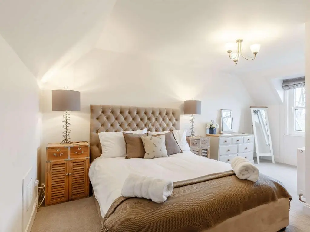 a bedroom with a large bed with white walls at 4 Bed in Wick 91390 in Wick