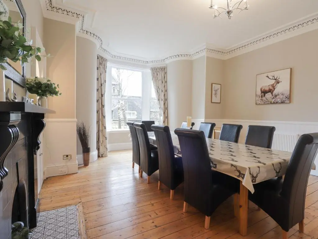 a dining room with a table and chairs at Arden House in Kingussie