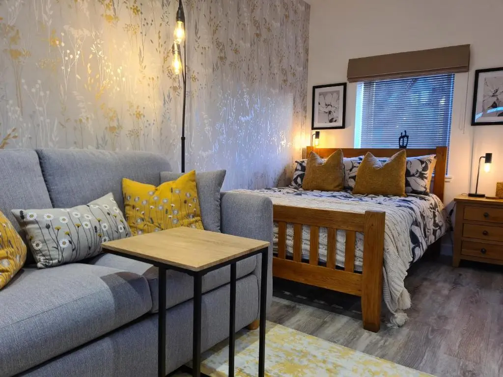 a living room with a couch and a bed at Findon Nook in Culbokie